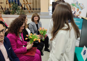 Uczennice wręczają kwiaty dyrektor hotelu Qubus w Łodzi oraz dyrektor ZSETH